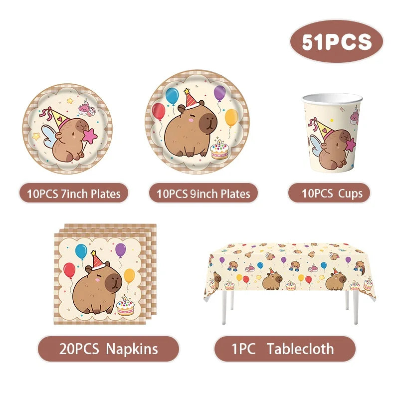 Set of party supplies including plates, cups, napkins, and a tablecloth with cartoon capybara design on a white background.