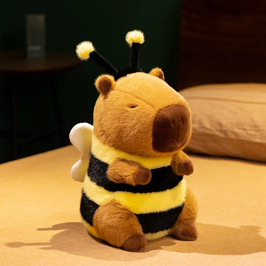 Plush toy capybara bee sitting on a surface with a blurred background