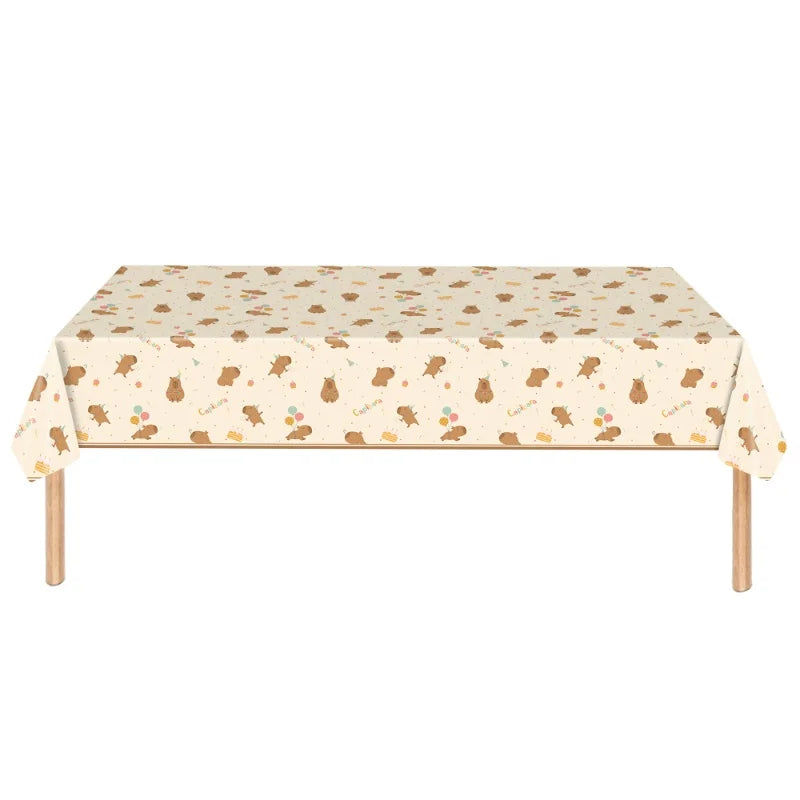 Table with a capybara patterned tablecloth on a white background