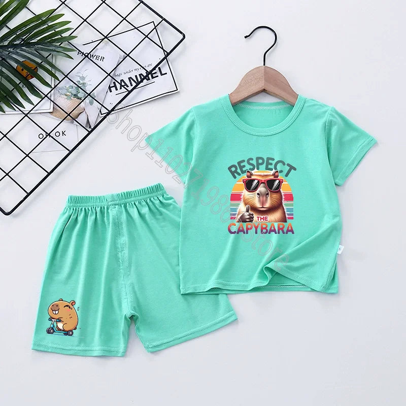 Teal t-shirt and shorts set with capybara design on a white background