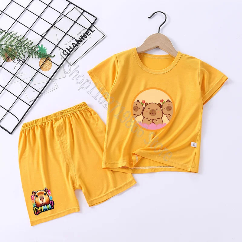 Yellow children's t-shirt and shorts set with capybara design on a white background