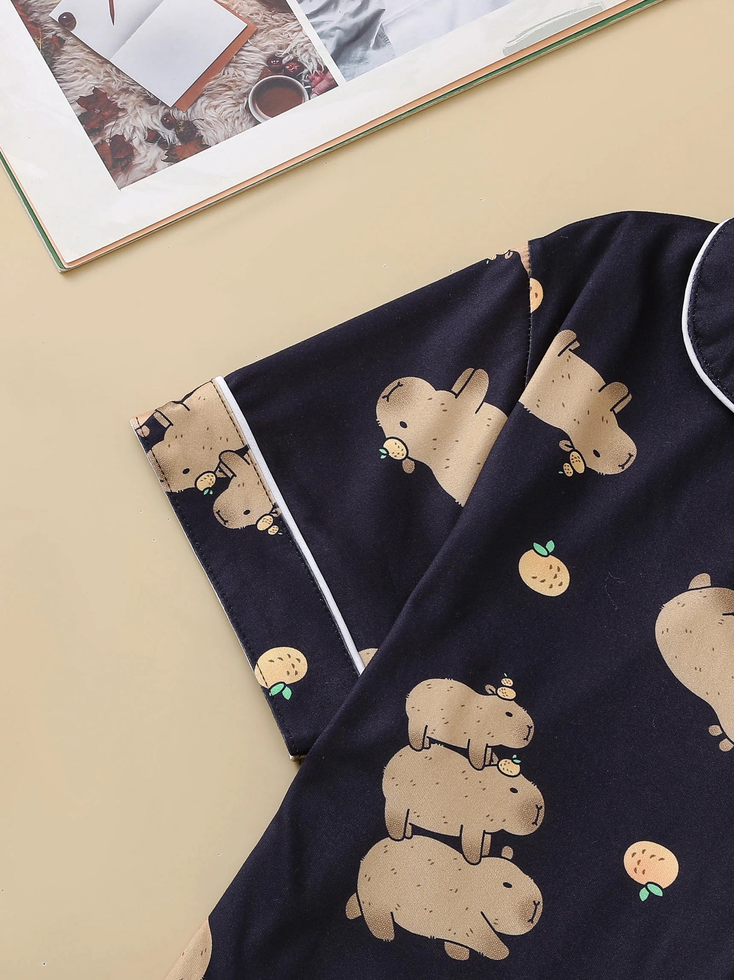 Navy blue fabric with beige capybara print on a beige background