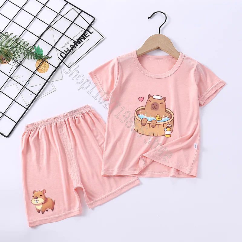 Pink pajama set with cartoon capybara design on a white background
