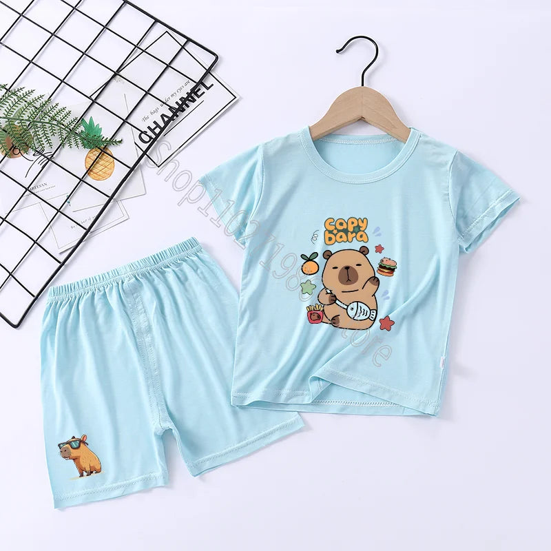 Light blue children's t-shirt and shorts set with cartoon capybara design on a white background.