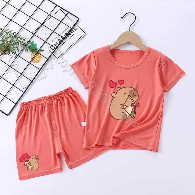 Coral children's capybara pajama set with cartoon design on a white background