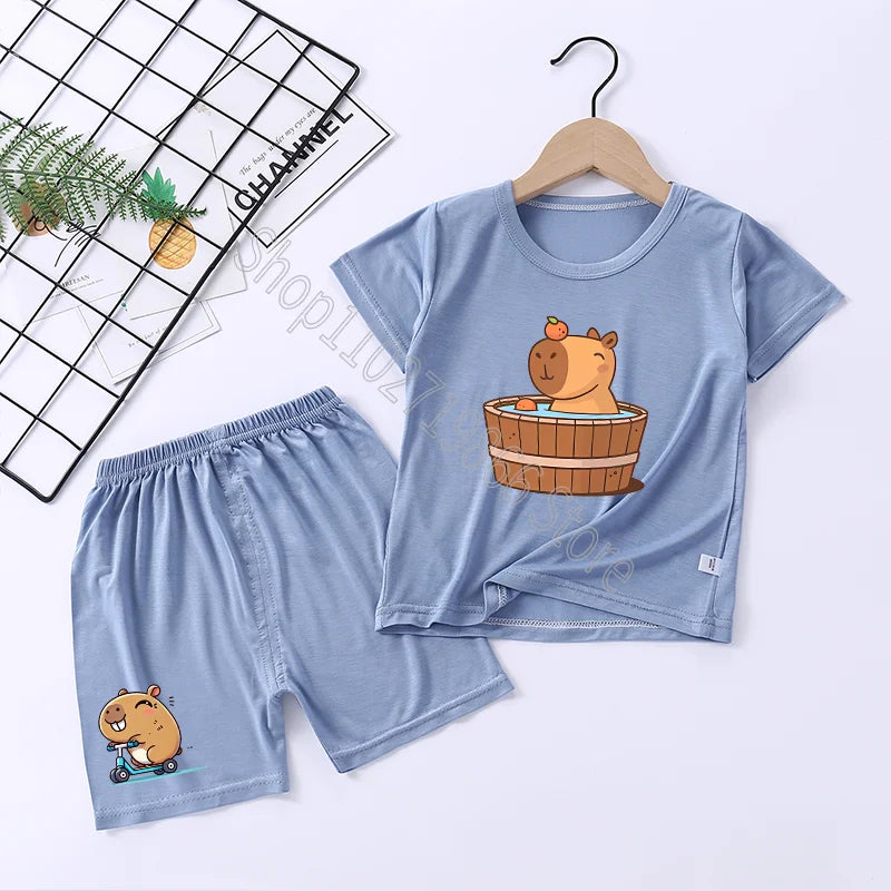 Children's blue pajama set with capybara cartoon designs on a white background