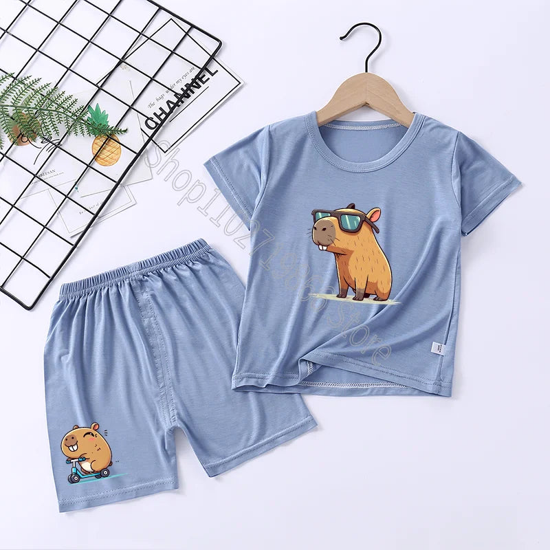 Blue pajama set with cartoon capybara design on a white background