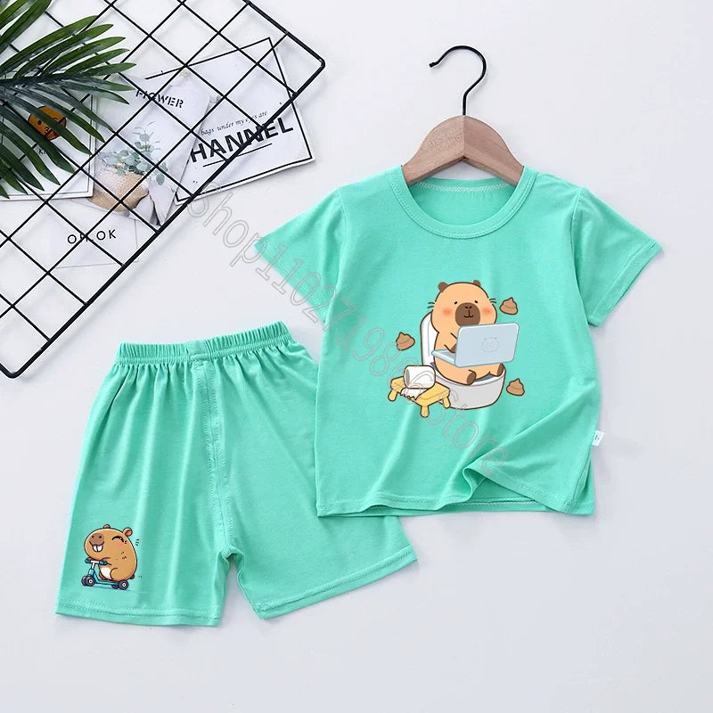 Children's green t-shirt and shorts set with capybara cartoon design on a white background
