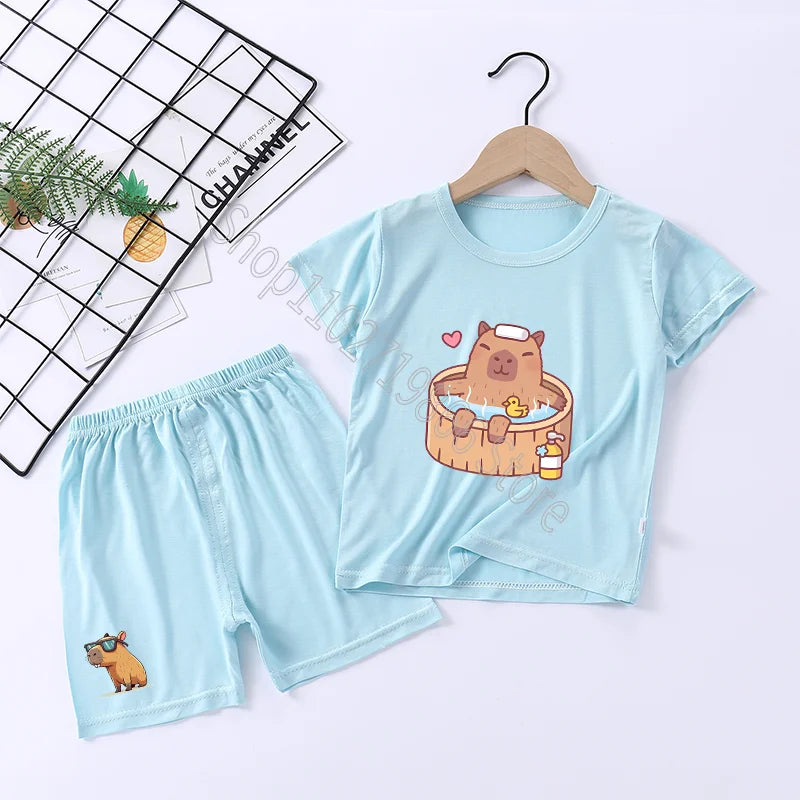 Light blue children's pajama set with cartoon capybara design on a white background