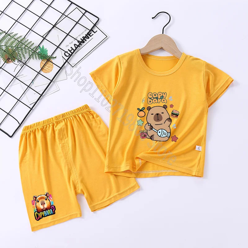Yellow children's t-shirt and shorts set with capybara cartoon design on a white background